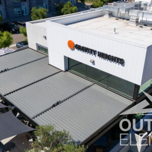 Aerial view of louvered pergola roof panels on commercial building rooftop
