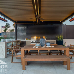 Wood dining table under pergola with infrared heaters and built-in grill kitchen