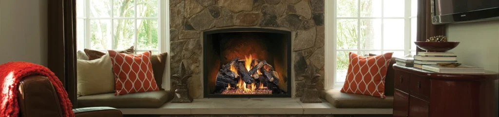 Real Fyre gas log set burning in a natural stone fireplace with realistic hand-painted logs