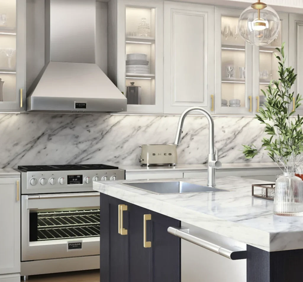 White kitchen with marble backsplash, stainless range hood and navy blue island cabinetry