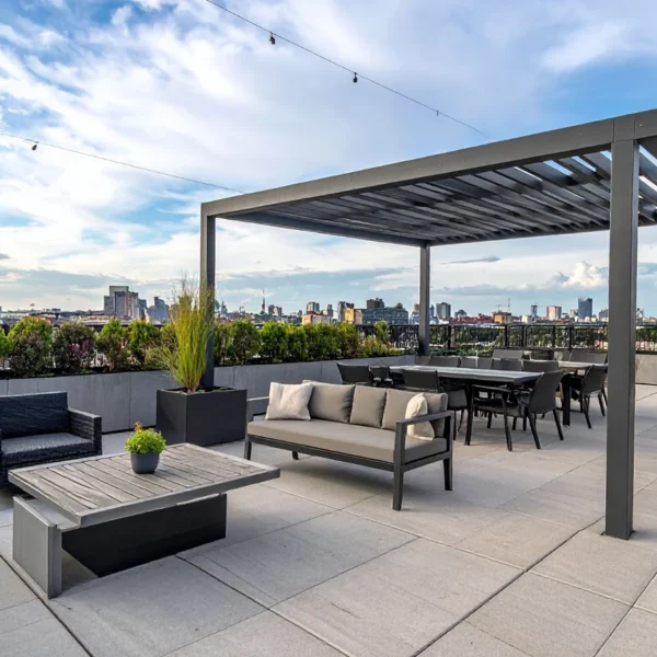 Rooftop terrace with modern louvered pergola, lounge seating, and dining set overlooking city skyline