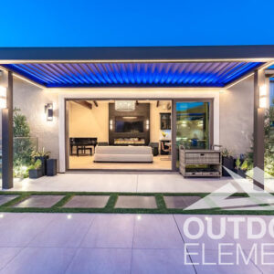 Pergola with blue LED lighting attached to home exterior with view into living room