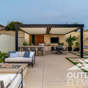 Backyard pergola with outdoor kitchen, dining table, and fire pit seating near pool