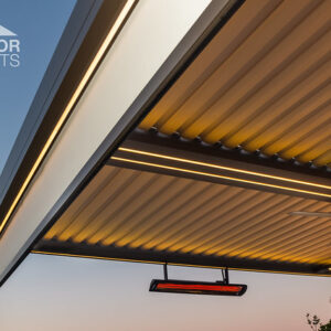 Close-up of infrared heater mounted under louvered pergola roof at dusk